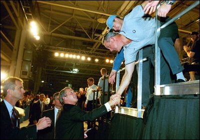 President George W. Bush takes a few moments to meet a few people during his visit to the BMW Manufacturing Corporation where he discussed jobs and the economy with employers and employees in Greer, S.C., Nov. 10, 2003.
