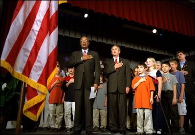 President George W. Bush and Education Secretary Rod Paige recite the "Pledge of Allegiance" with students at the East Literature Magnet School in Nashville, Tenn., Sept. 17, 2002. Committed to educational excellence in America, the President and Mrs. Bush launched programs such as "No Child Left Behind," "Ready to Read, Ready to Learn," and "Reading First." Education is a priority issue for them. Reaching out to share their vision, they have made it a practice to visit schools across the nation to meet one on one with teachers and students. 