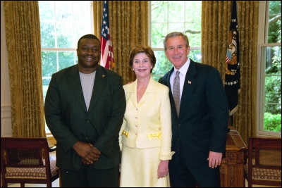 President George W. Bush and Laura Bush congratulate 2003 Maine Teacher of the Year William Randy Scott in the Oval Office Wednesday, April 30, 2003. White House Photo by Eric Draper