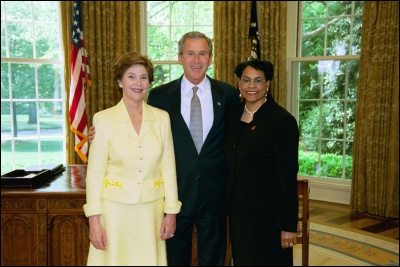 President George W. Bush and Laura Bush congratulate 2003 Maine Teacher of the Year Audrey Ferguson in the Oval Office Wednesday, April 30, 2003. White House Photo by Eric Draper