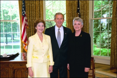 President George W. Bush and Laura Bush congratulate 2003 Maine Teacher of the Year Marilyn Benz Lindquist in the Oval Office Wednesday, April 30, 2003. White House Photo by Eric Draper