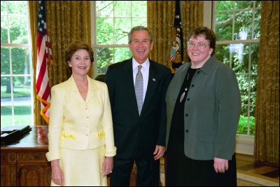 President George W. Bush and Laura Bush congratulate 2003 Maine Teacher of the Year Jennifer J. Montgomery in the Oval Office Wednesday, April 30, 2003. White House Photo by Eric Draper