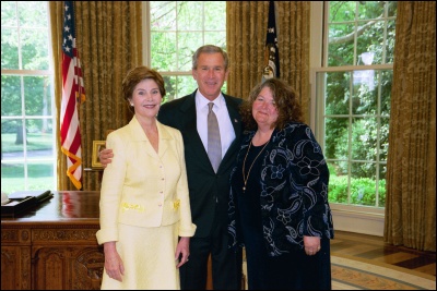 President George W. Bush and Laura Bush congratulate 2003 Maine Teacher of the Year Macie Kathleen Wolfe in the Oval Office Wednesday, April 30, 2003. White House Photo by Eric Draper