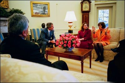 President George W. Bush talks with Idres Hawarry, Della Jaff and Dr. Katrin Michael, survivors of a chemical weapons attack in Halabja, Iraq, during a meeting in the Oval Office, March 14, 2003. Halbja is a Kurdish village in Northern Iraq where a chemical weapons attack killed 5, 000 people 15 years ago.