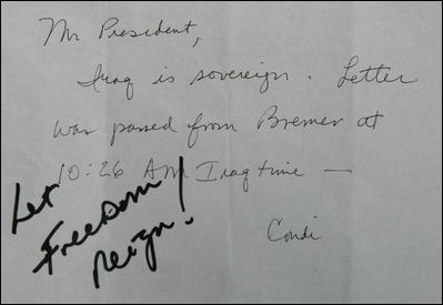President George W. Bush wrote, "Let Freedom Reign" in response to a note passed to him by Dr. Condoleezza Rice while attending the opening session of a NATO summit June 28, 2004, in Istanbul, Turkey.