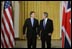 President George W. Bush and British Prime Minister Tony Blair walk through the Cross Hall of the White House before the start of their news conference, Thursday, July 17, 2003.