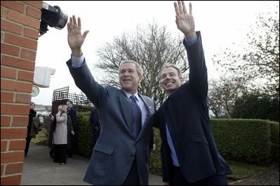 President George W. Bush and Prime Minister Tony Blair wave to onlookers during the President's visit to the Blair's home. White House photo by Eric Draper