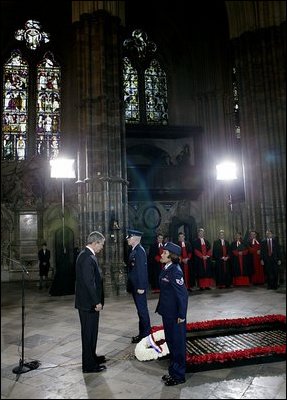 President George W. Bush bows his head in silence as a wreath is laid at the Tomb of the Unknown Warrior at Westminster Abbey in London Thursday, Nov. 20, 2003. White House photo by Eric Draper