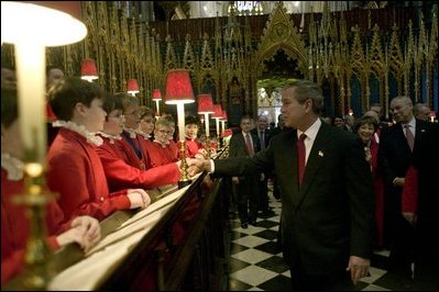 After listening to the Westminster Abbey Choir perform, President George W. Bush greets one of the younger choir members during his and Mrs. Bush's tour of the abbey Thursday, Nov. 20, 2003. White House photo by Eric Draper