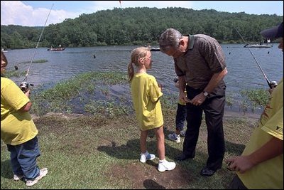 During a visit to Oak Mountain State Park, President Bush confers with a young YMCA day camper June 21, 2001.