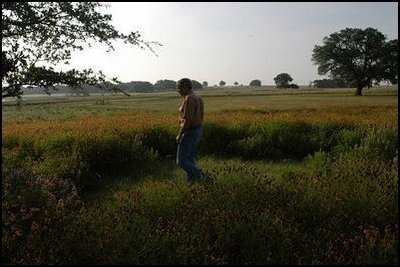 President Bush takes a walk among wild flowers at his Ranch in Crawford, Texas, May 23, 2003.