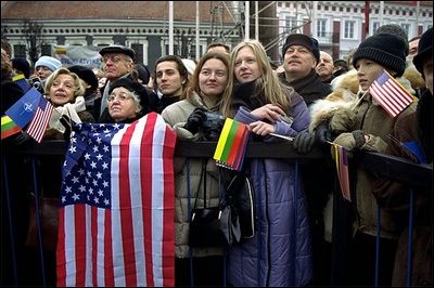Waiting for President Bush and President Adamkus, old and young Lithuanians hold the American and Lithuanian flags at Rotuse Square in Vilnius, Lithuania, Nov. 23, 2002. 'You (the Lithuanian people) have known cruel oppression and withstood it. You were held captive by an empire and you outlived it. And because you have paid its cost you know the value of human freedom,' said President Bush in his remarks. 'Lithuania today is true to its best traditions of democracy and tolerance and religious liberty, and you have earned the respect of my nation and all nations.' White House photo by Susan Sterner
