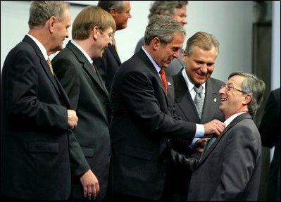Preparing for a group photo at the NATO Summit, President George W. Bush jokes with Luxembourg's Prime Minister Jean-Claude Juncker at the Prague Congress Centre in Prague, Czech Republic, Nov. 21, 2002. Also pictured are, from left to right, Canadian Prime Minister Jean Chretien, Belgian Prime Minister Guy Verhofstadt, and Poland's President Aleksander Kwasniewski. White House photo by Paul Morse