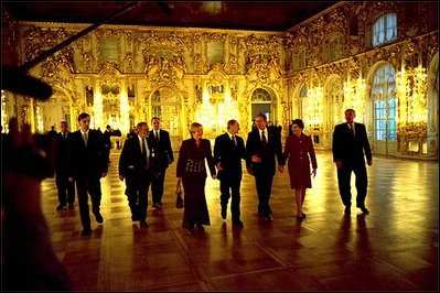 Before their bilateral meetings, President Putin and Lyudmila Putin escort President Bush and Laura Bush through the Great Hall at Catherine Palace in St. Petersburg, Russia, Nov. 22, 2002. White House photo by Eric Draper