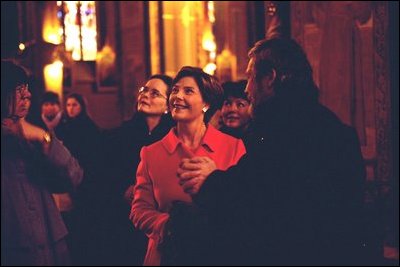 Laura Bush, joined by Debbie Stapleton, wife of U.S. Ambassador to the Czech Republic, left, and Press Secretary Noelia Rodriguez, right, listens to a tour of Vysehrad Church of Saints Peter and Paul in Prague, Czech Republic Thursday, Nov. 21, 2002. White House photo by Susan Sterner.