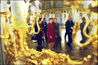 Laura Bush and Ludmila Putin, wife of Russian President Valdimir Putin, are reflected in a gilded mirror as they walk through one of the great halls of Catherine's Palace outside St. Petersburg, Russia. White House photo by Susan Sterner.