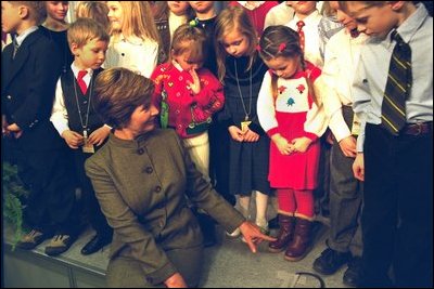 Laura Bush jokes with some children of embassy employees at the American Center in Vilnius, Lithuania Saturday, November 23, 2002. White House photo by Susan Sterner.