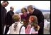 President George W. Bush and Laura Bush are greeted by children at the airport in Bucharest, Romania Saturday, Nov. 23, 2002. White House photo by Susan Sterner