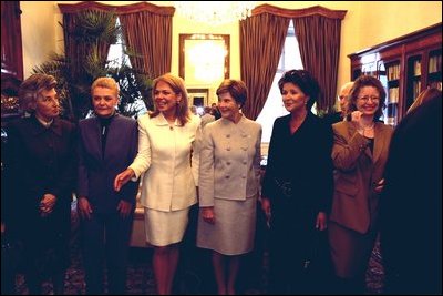 Laura Bush stands between the First Lady of Poland Jolenta Kwasneiska, third right, and First Lady of the Czech Republic , Dagmar Havlova, third left, as other spouses to NATO heads of state line up for a photo-op prior to a luncheon hosted by Dagmar Havlova at a Presidential retreat outside Prague. White House photo by Susan Sterner.