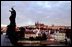Viewed from the St. Charles bridge, Prague castle is lit by a sun rising over the Czech Republic's capital city.