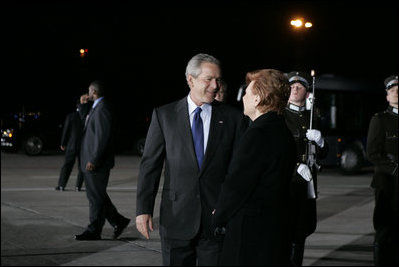 President George W. Bush and Latvia's President Vaira Vike-Freiberga pause for a moment at Riga International Airport after the President and Mrs. Bush arrived on the first stop of their four-day, four-country visit to Europe.