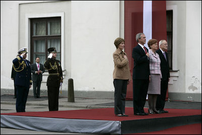President George W. Bush and Laura Bush and Latvia President Vaira Vike-Freiberga and husband Imants Freibergs stand for the playing of the American national anthem Saturday, May 7, 2005, at Riga Castle in Riga, Latvia.