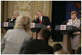 From left, Lithuanian President Valdas Adamkus, President George W. Bush and Latvia President Vaira Vike-Freiberga adjust their earphones to hear interpreters during a question and answer session Saturday, May 7, 2005, in Riga, Latvia.