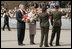 President George W. Bush and Latvia's President Vaira Vike-Freiberga participate in a wreath-laying ceremony in front of the Freedom Monument in Riga, May 7, 2005.
