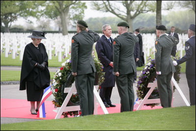Queen Beatrix of The Netherlands and President George W. Bush pause in respect before wreaths at the Netherlands American Cemetery Sunday, May 8, 2005, in Margraten, honoring those who served during World War II.