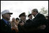 President George W. Bush greets veterans at the Netherlands American Cemetery in Margraten Sunday, May 8, 2005, following a ceremony honoring those who served in World War II.