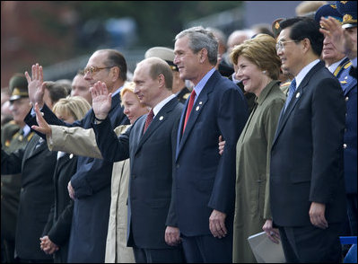 President George W. Bush and Laura Bush stand with Russian President Vladimir Putin and Ludmila Putina, French President Jacque Chirac, far left, and Chinese President Hu Jintao, right, as many heads of state watch a parade in Moscow's Red Square commemorating the end of World War II Monday, May 9, 2005.