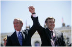 President George W. Bush and President Mikhail Saakashvili of Georgia react to the cheering of thousands of Tbilisi citizens in Freedom Square Tuesday, May 10, 2005.  "You are building a democratic society where the rights of minorities are respected, where a free press flourishes, a vigorous opposition is welcome, and unity is achieved through peace," said the President in his remarks. "In this new Georgia, the rule of law will prevail, and freedom will be the birthright of every citizen."  