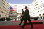 President George W. Bush walks with President Mikhail Saakashvili during an arrival ceremony in the courtyard of the Parliament Building in Tbilisi, Georgia, Tuesday, May 10, 2005.