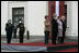 President George W. Bush and Laura Bush and Latvia President Vaira Vike-Freiberga and husband Imants Freiberg stand for the playing of the American national anthem Saturday, May 7, 2005, at the Freedom Monument in Riga, Latvia.