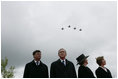Jan Peter Balkenende, Prime Minister of The Netherlands, left, President George W. Bush, Queen Beatrix of The Netherlands, and Mrs. Laura Bush stand on stage Sunday, May 8, 2005, at the Netherlands American Cemetery in Margraten, as a flyover marks the remembrance of those who served in World War II.