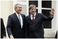 President George W. Bush and Belgian Prime Minister Guy Verhofstadt wave to the press outside the Prime Minister's office in Brussels, Belgium, Feb. 21, 2005.