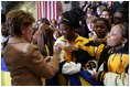Laura Bush signs autographs for students of General H. H. Arnold High School following her remarks there to students, faculty and parents of the military in Wiesbaden, Germany, Tuesday, Feb. 22, 2005. 