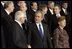 President George W. Bush speaks with Czech President Vaclav Klaus as world leaders take their place for the official NATO photo at the NATO Headquarters in Brussels Tuesday, Feb. 22, 2005. 