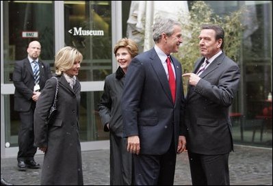 President George W. Bush, Laura Bush, German Chancellor Gerhard Schroeder, right, and Mrs. Schroeder-Koepf, left, visit before touring the Gutenberg Museum in Mainz, Germany, Feb. 23, 2005.