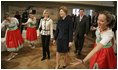 Laura Bush watches dancers during a Wednesday, Feb. 23, 2005, lunch hosted by Chancellor Gerhard Schroeder, behind, and Mrs. Schroeder-Koepf, left, at the Electoral Palace in Mainz, Germany.