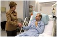 Laura Bush visits with U.S. Army Specialist Garrett Larson who is recovering from injuries sustained in Iraq at the Landstuhl Regional Medical Center Tuesday, Feb. 22, 2005, in Ramstein, Germany. 