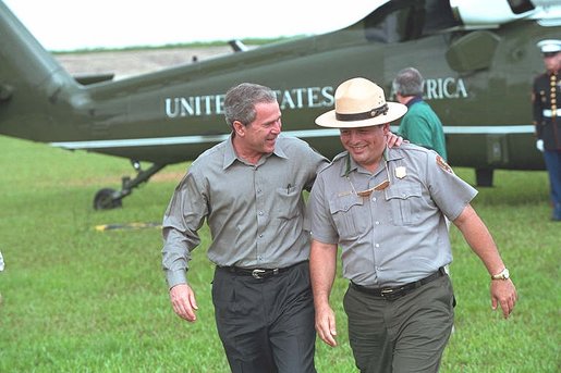 President George W. Bush talks with national park service officers at the Royal Palm Visitors Center at Everglades National Park, Fla., June 4, 2001. White House photo by Eric Draper.