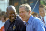 President George W. Bush takes in the excitement of the White House Fitness Expo on the South Lawn with Dallas Cowboys Running Back Emmitt Smith June 20.