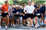 President George W. Bush starts the 3 mile run while Mrs. Bush, #2, starts the 1.5 mile walk at Ft. McNair as part of The President's Fitness Challenge on Saturday June 21, 2002. White House Photo by Paul Morse