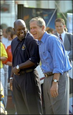 President George W. Bush takes in the excitement of the White House Fitness Expo on the South Lawn with Dallas Cowboys Running Back Emmitt Smith June 20. 