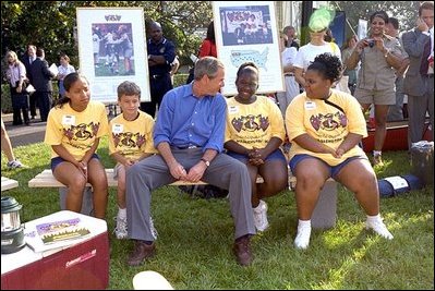 Touring the exhibits, President Bush takes a few moments to visit with children at the hiking/outdoor activity exhibit. 