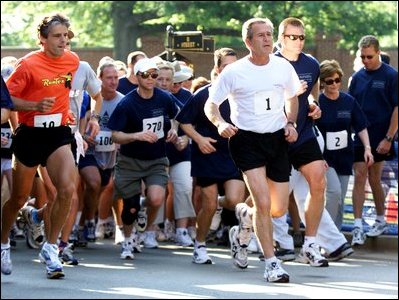 President George W. Bush starts the 3 mile run while Mrs. Bush, number 2, starts the 1.5 mile walk at Ft. McNair as part of The President's Fitness Challenge on Saturday June 21, 2002.