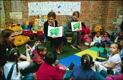 Laura Bush and Marta Sahagun de Fox, the First Lady of Mexico, tour Martha's Table, Washington, D.C., March 31, 2004. They assist volunteers preparing sandwiches and soup and read to children in the Preschool Room.