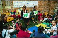 Laura Bush and Marta Sahagun de Fox, the First Lady of Mexico, tour Martha's Table, Washington, D.C., March 31, 2004. They assist volunteers preparing sandwiches and soup and read to children in the Preschool Room.