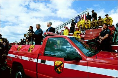 President Bush stands with California Governor-elect Arnold Schwarzenegger, left, and California Governor Gray Davis as he addresses off-duty firefighters and volunteers in El Cajon, Calif., Nov. 4, 2003.
